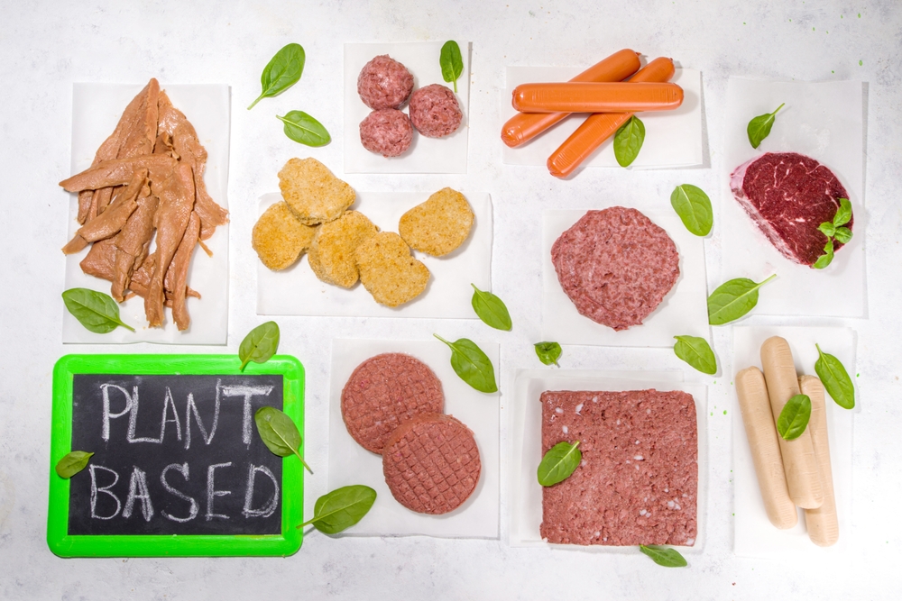 Green meat, various vegan plant based meat alternatives in different kinds – steak, minced meat, burger cutlet, nuggets, hot dog sausages, meatballs, strips