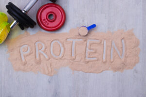 protein powder and dumbbells or gym weights
