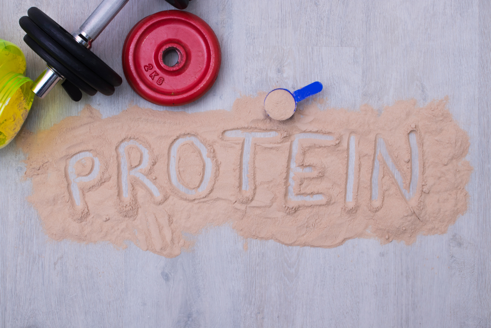 protein powder and dumbbells or gym weights